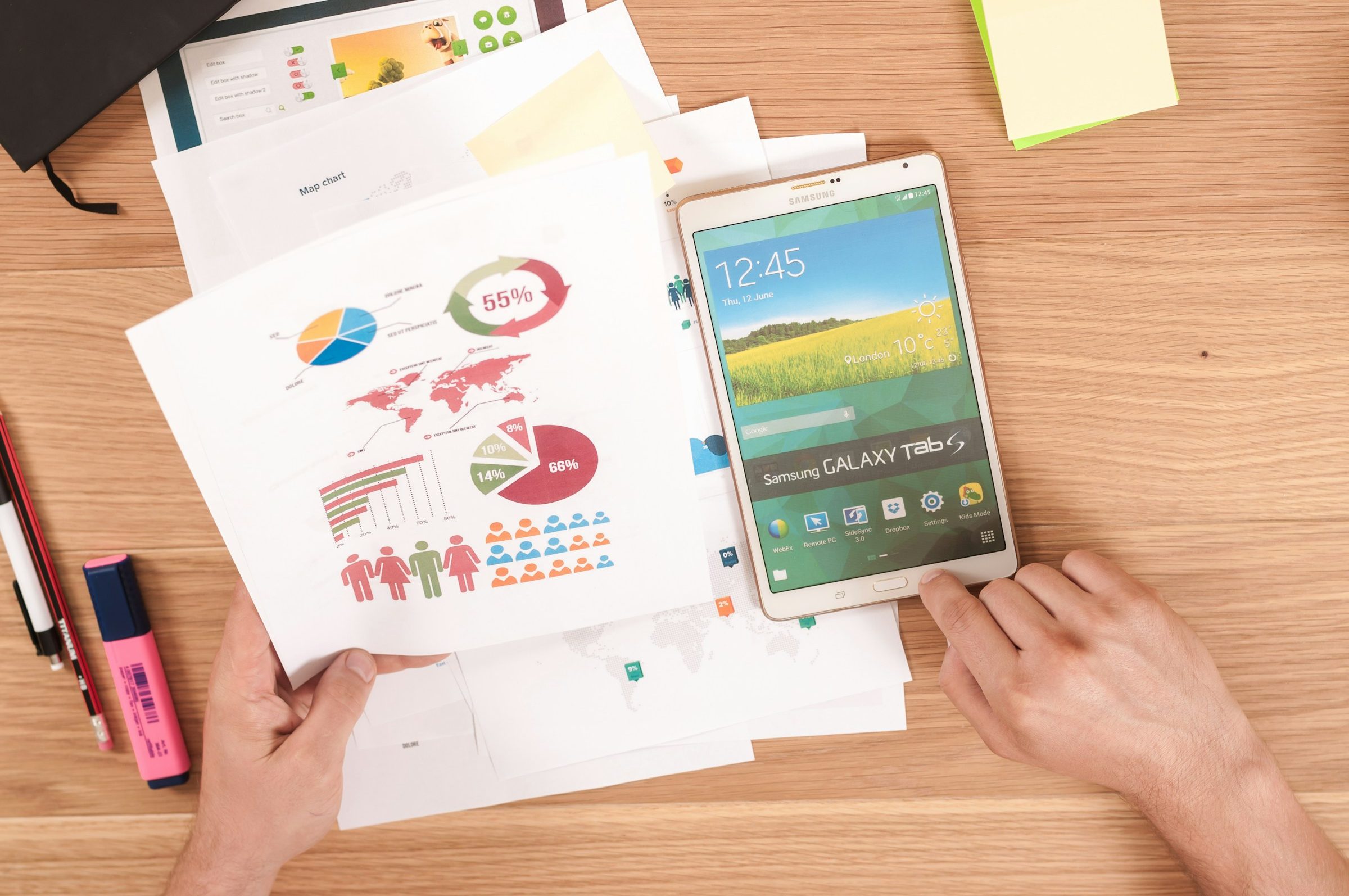 strategic planning frameworks person designing graphics with a smart phone and papers